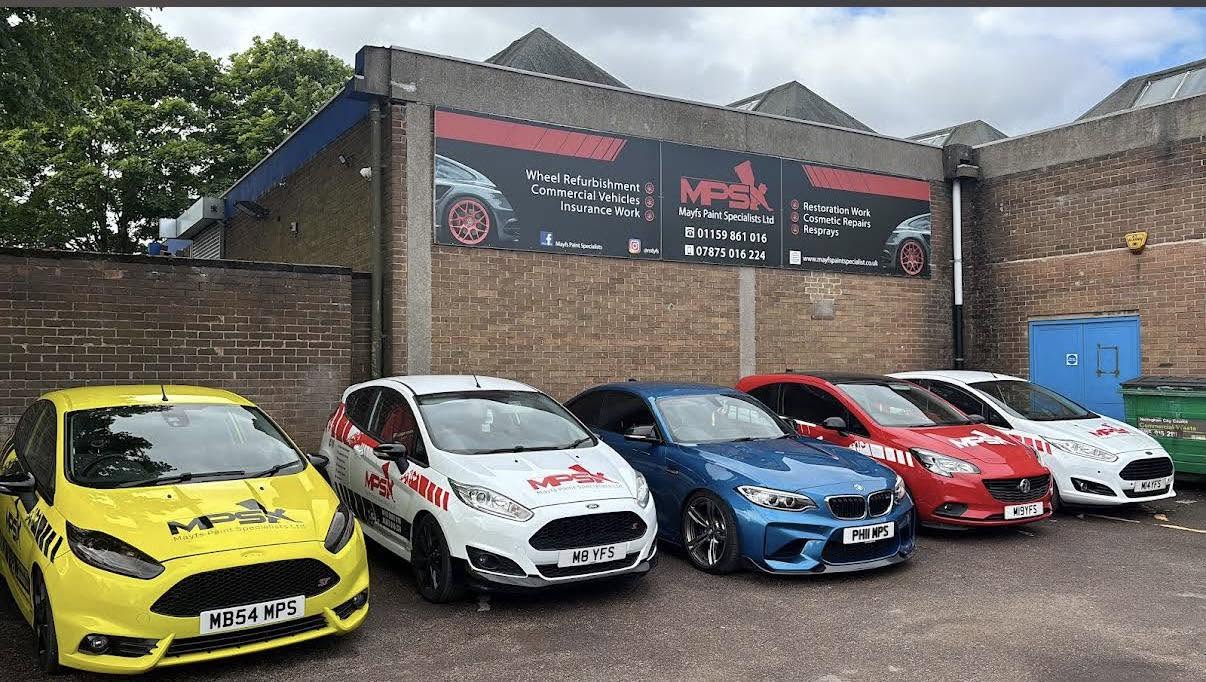 Mayfs Paint Specialists workshop in Nottingham with branded vehicles parked outside