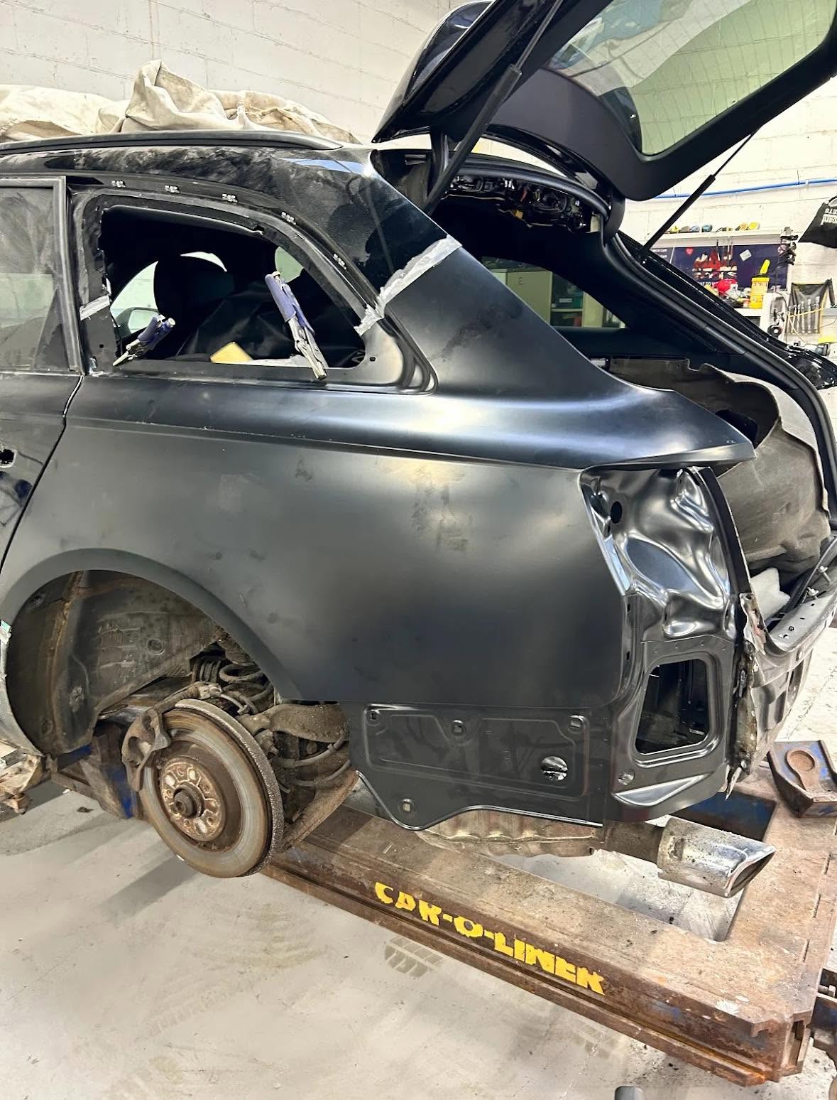 Vehicle rear quarter panel repair in progress